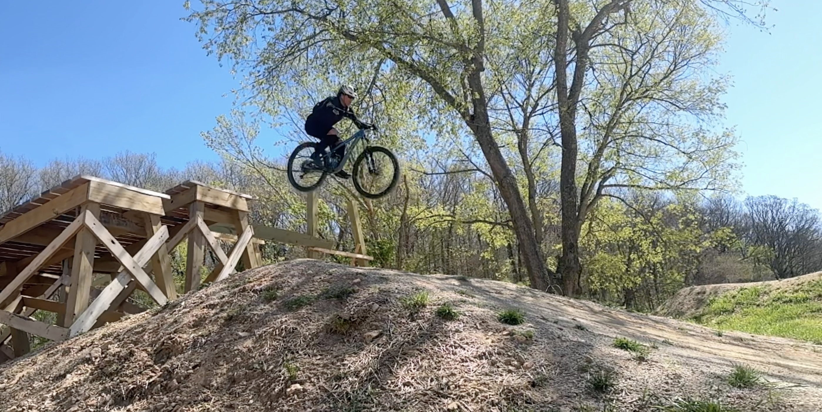 Jumping a mountain bike off a wooden ramp